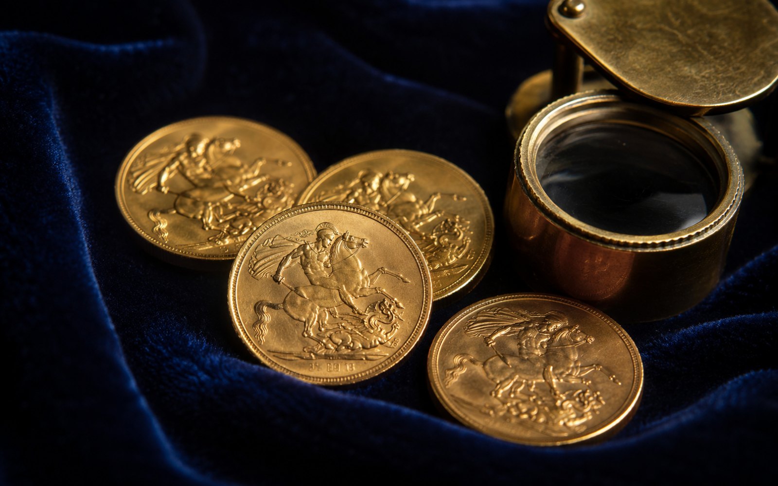Britische Sovereign-Goldmünzen mit St. George auf blauem Samt mit Lupe
